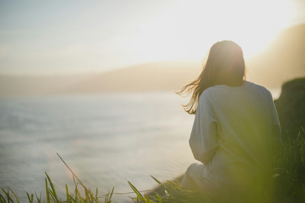 Woman looking out at the ocean thinking about why am I so sensitive.